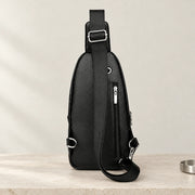 Dos de la sacoche bandoulière noire avec poche zippée et sangle réglable